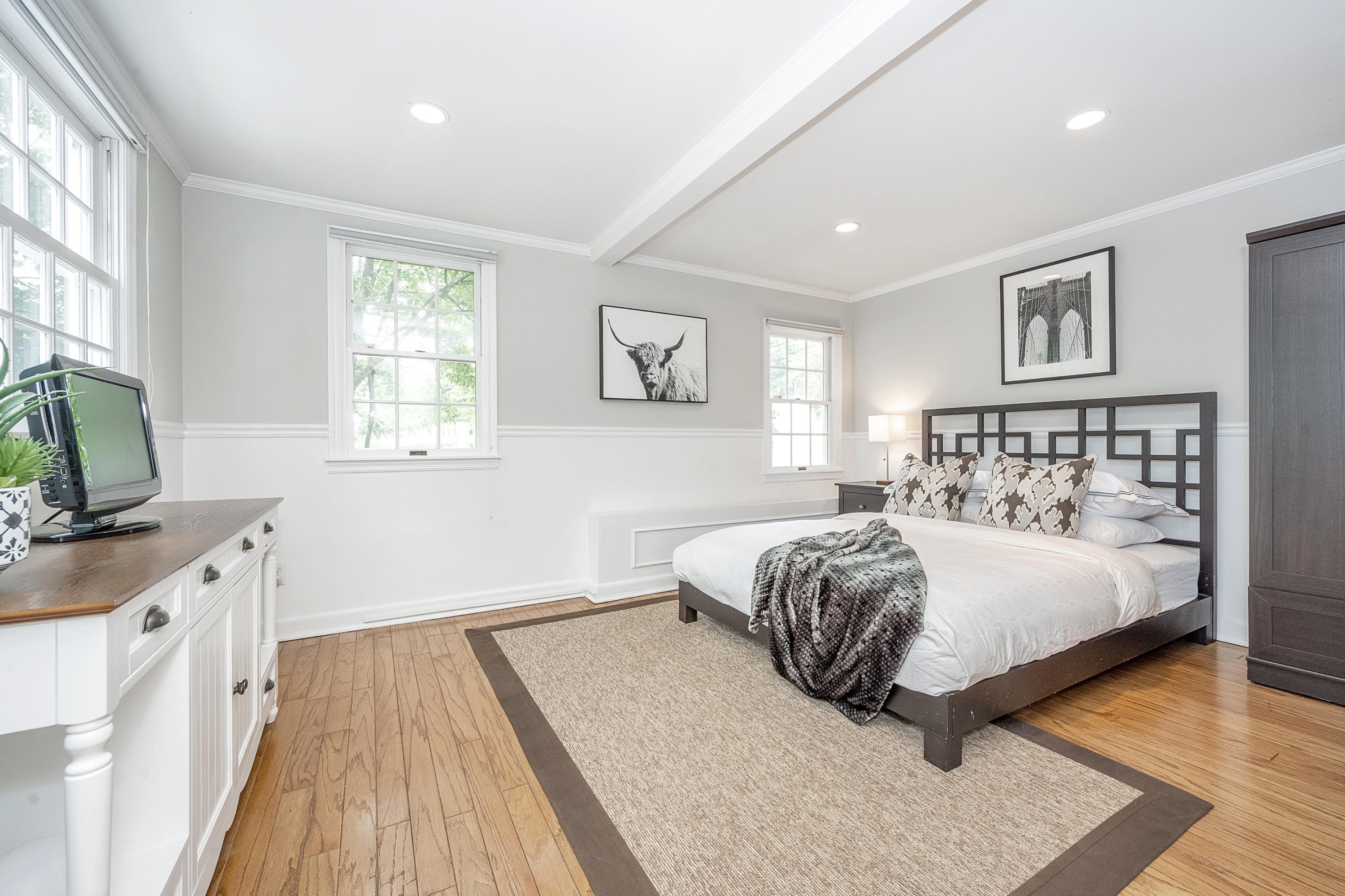 107 Hollow Tree Ridge Road Darien, CT 06820 - Photo 13 of 32 a spacious bedroom with a bed and a flat screen tv
