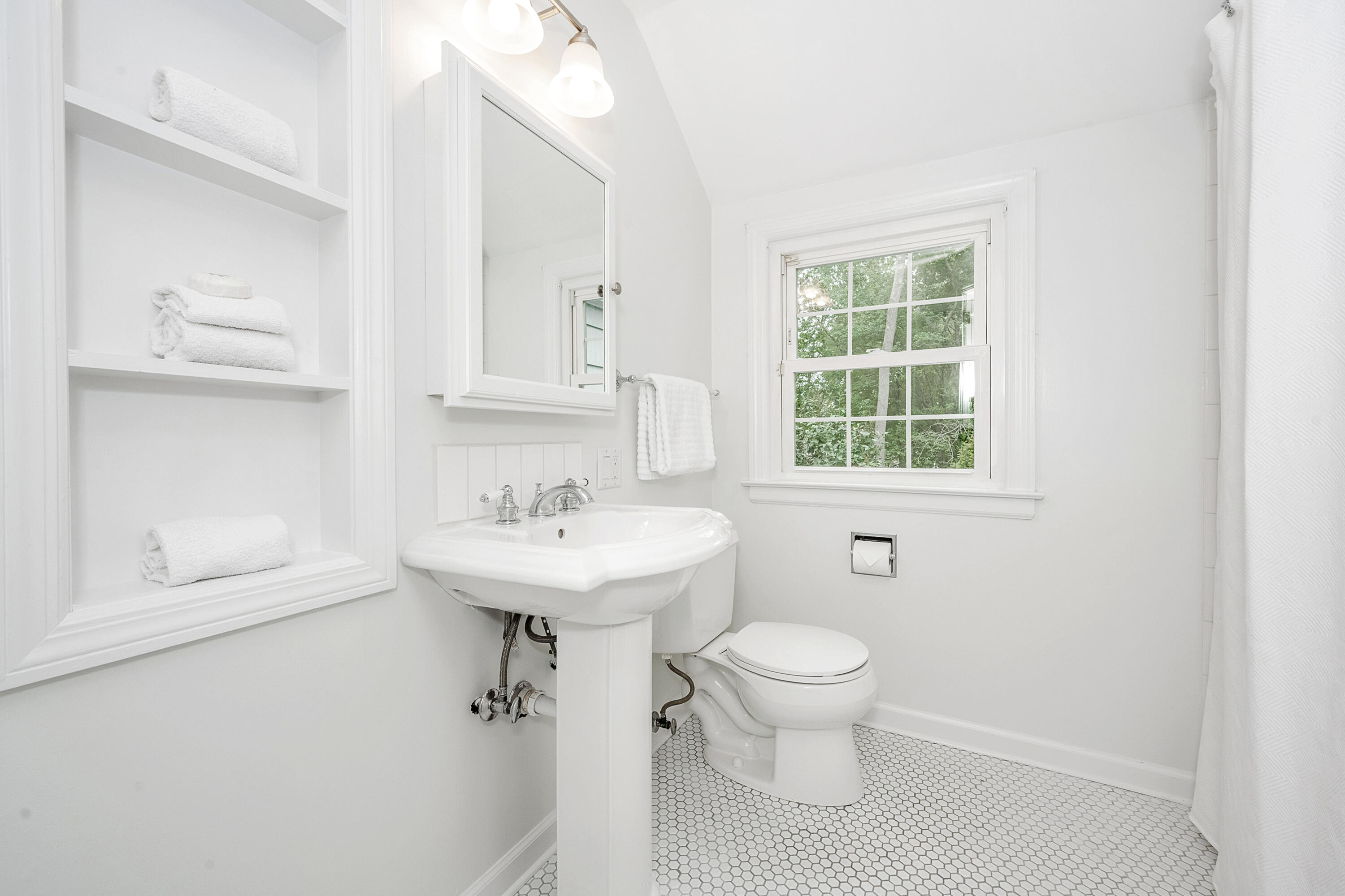 107 Hollow Tree Ridge Road Darien, CT 06820 - Photo 17 of 32 a bathroom with a sink toilet and a mirror