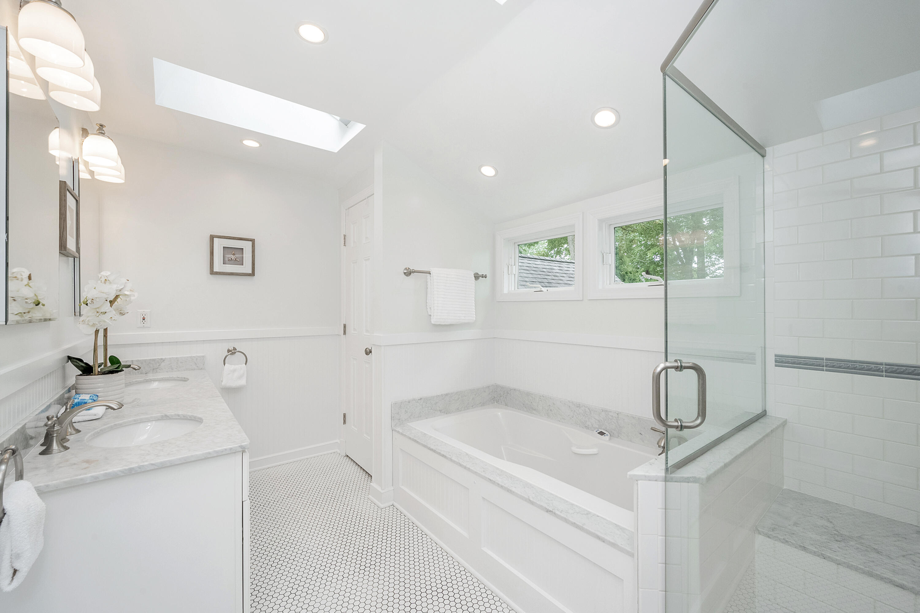 107 Hollow Tree Ridge Road Darien, CT 06820 - Photo 19 of 32 a bathroom with a sink a toilet and a mirror