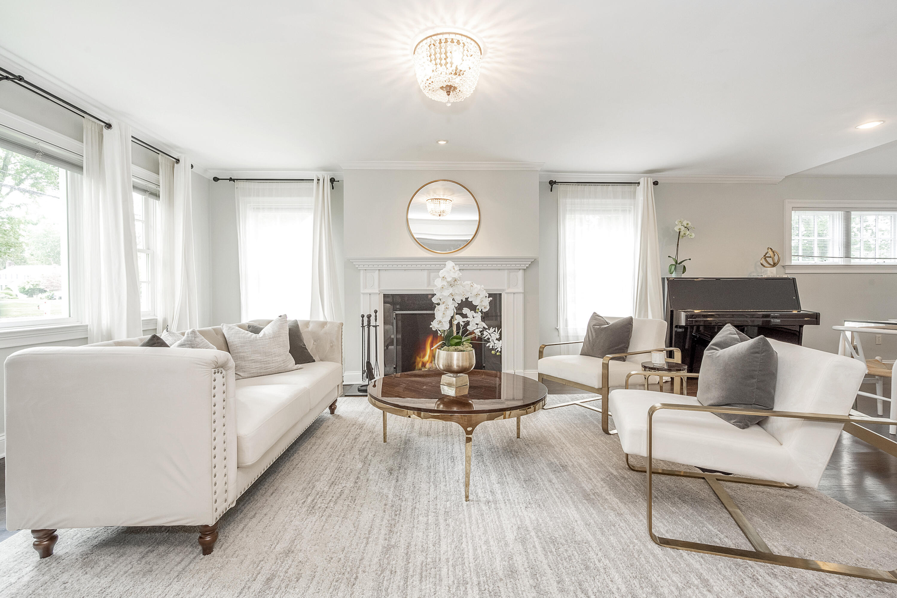 107 Hollow Tree Ridge Road Darien, CT 06820 - Photo 3 of 32 a living room with furniture a clock and a large window