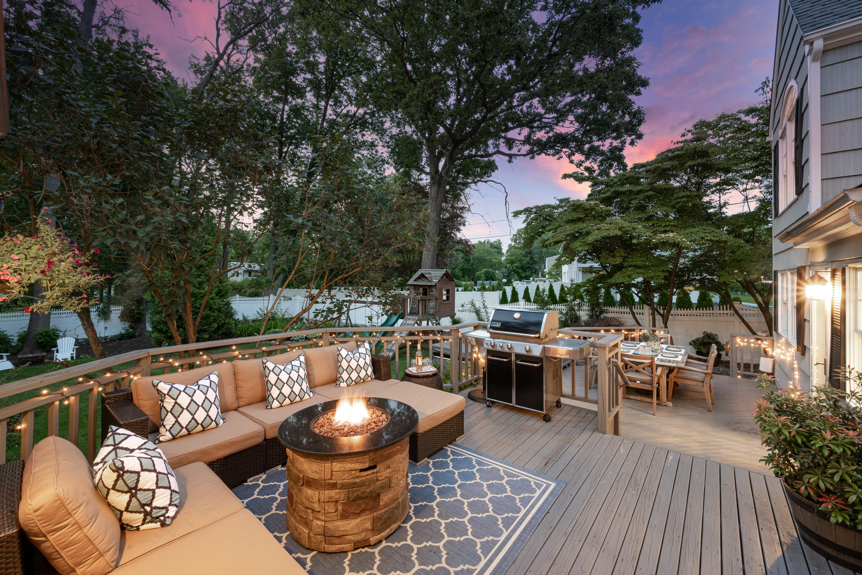 107 Hollow Tree Ridge Road Darien, CT 06820 - Photo 24 of 32 a view of a roof deck with table and chairs potted plants and a large tree