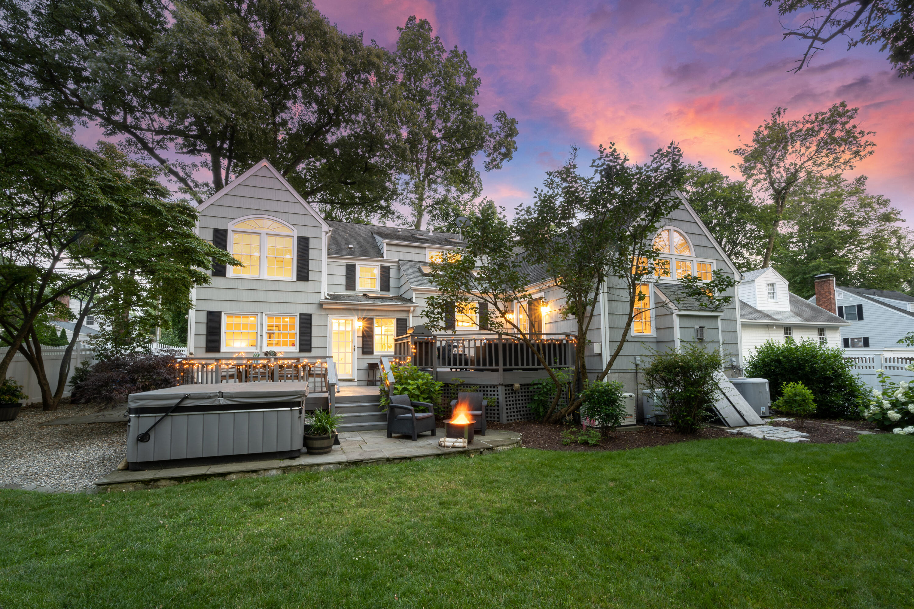 107 Hollow Tree Ridge Road Darien, CT 06820 - Photo 27 of 32 a front view of a house with a garden and trees