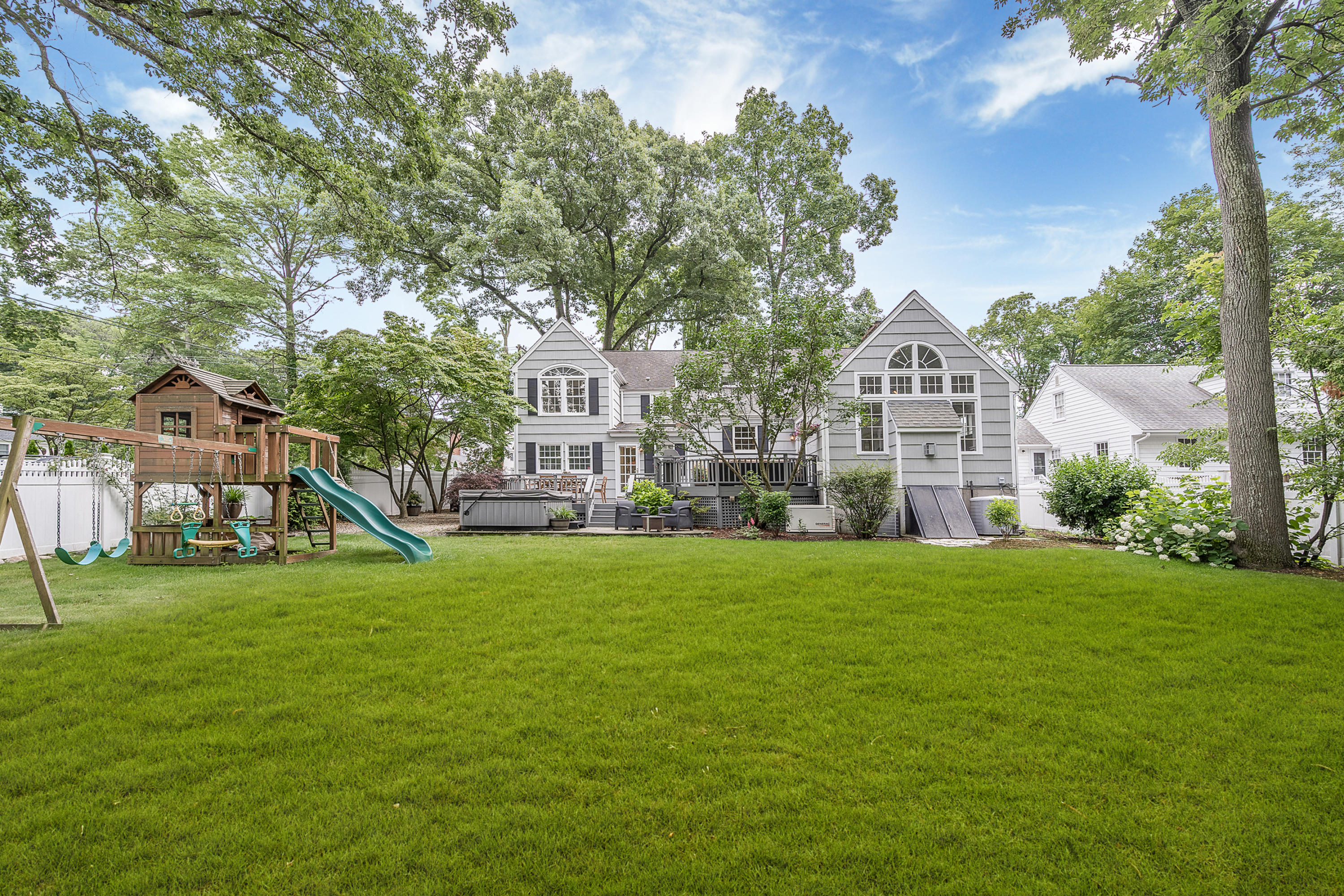 107 Hollow Tree Ridge Road Darien, CT 06820 - Photo 28 of 32 a view of a big house with a big yard and large trees