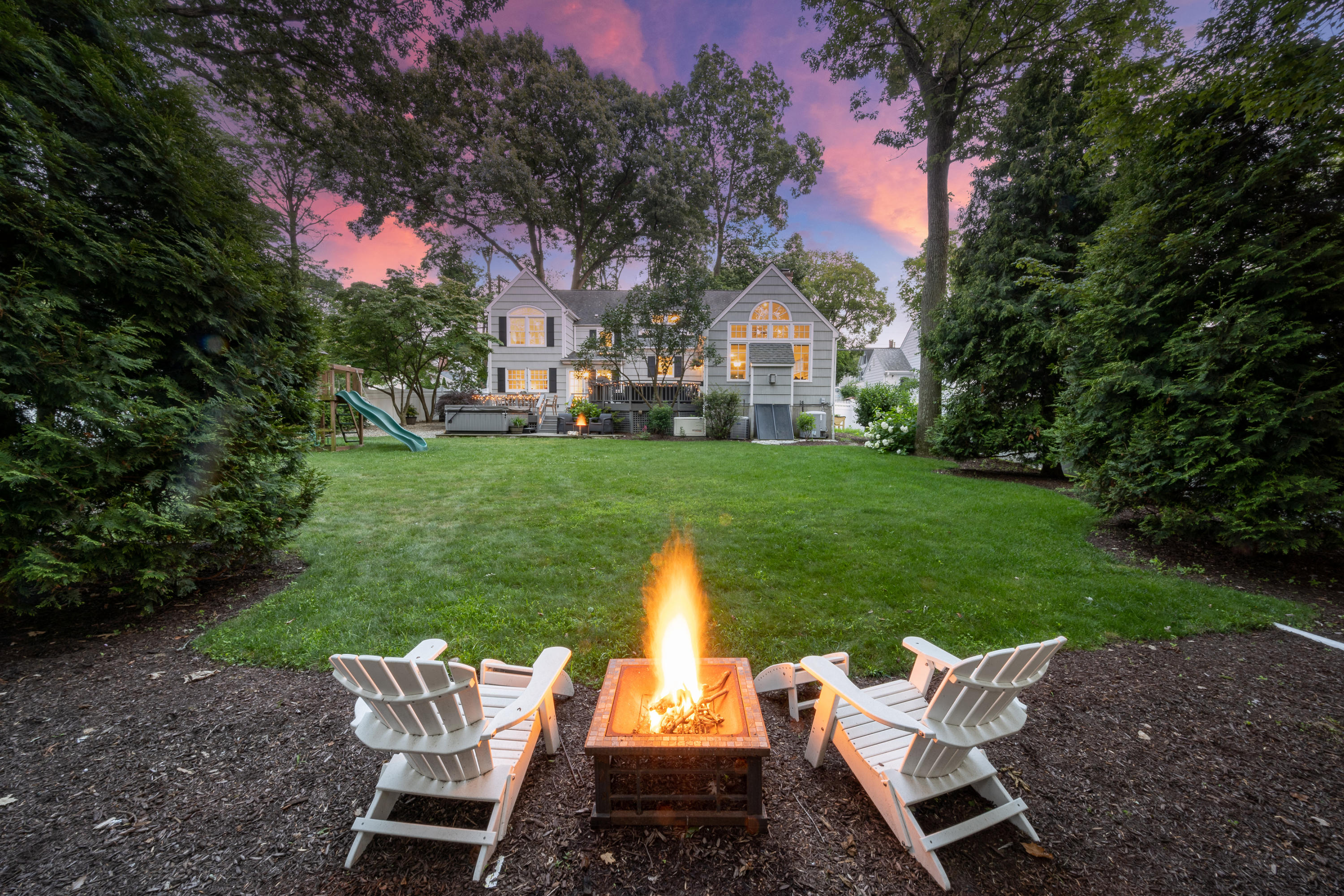 107 Hollow Tree Ridge Road Darien, CT 06820 - Photo 29 of 32 a view of a table and chairs in the garden