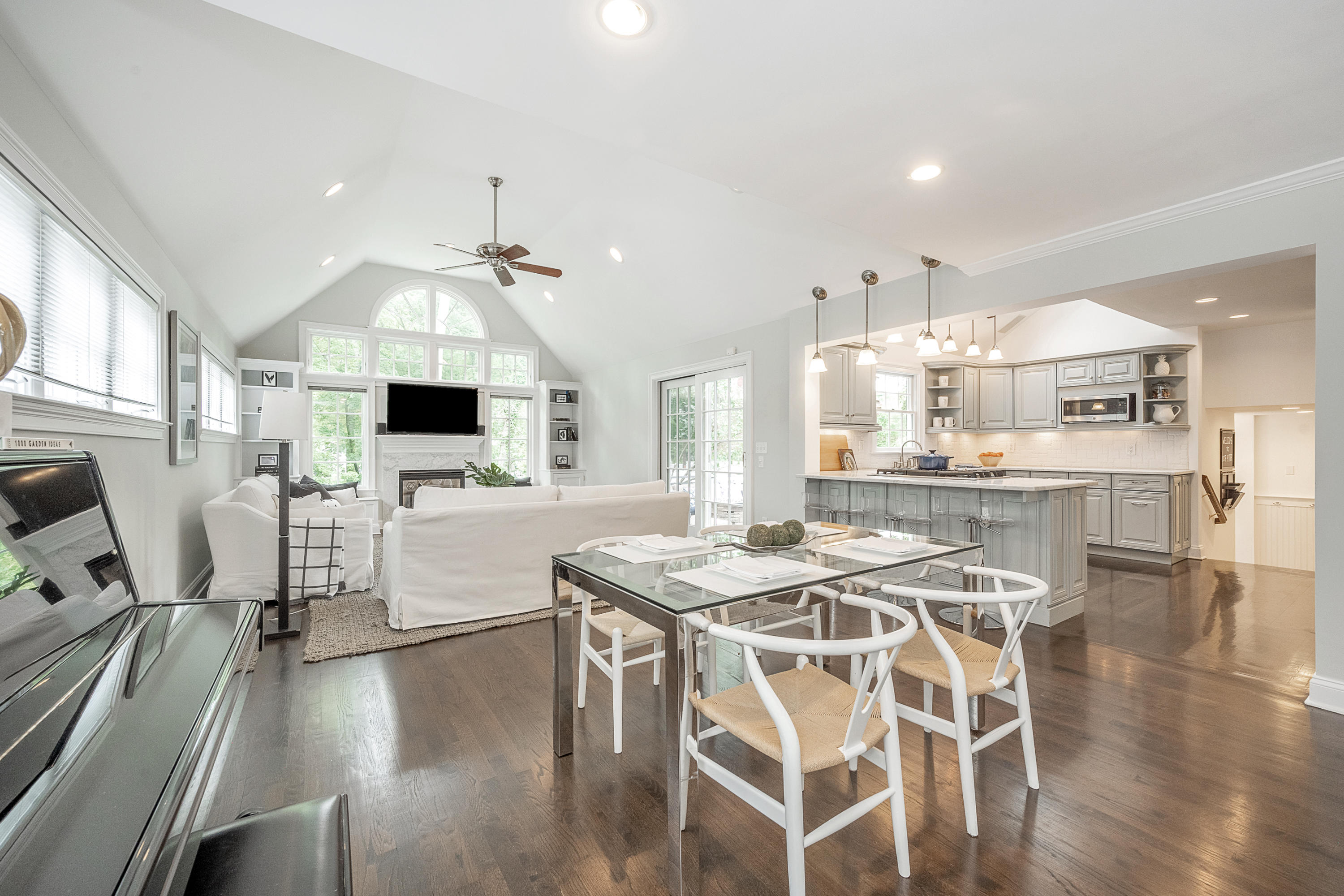 107 Hollow Tree Ridge Road Darien, CT 06820 - Photo 8 of 32 a kitchen with stainless steel appliances kitchen island granite countertop a stove a sink a dining table and chairs with wooden floor