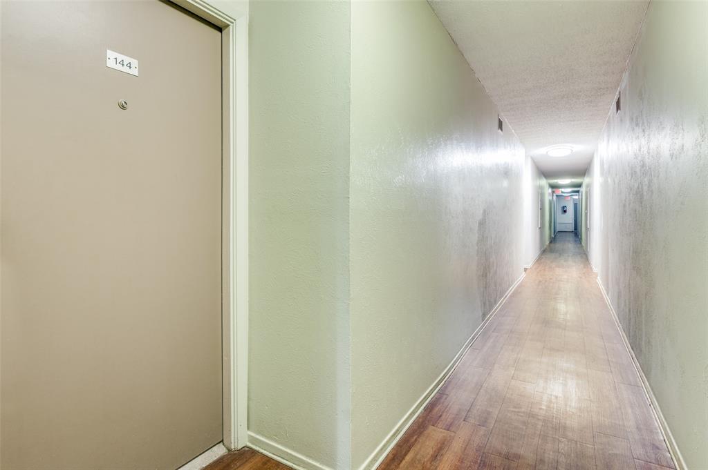 4859 Cedar Springs Road, Unit 144 Dallas, TX 75219 - Photo 2 of 14 a view of a hallway with wooden floor