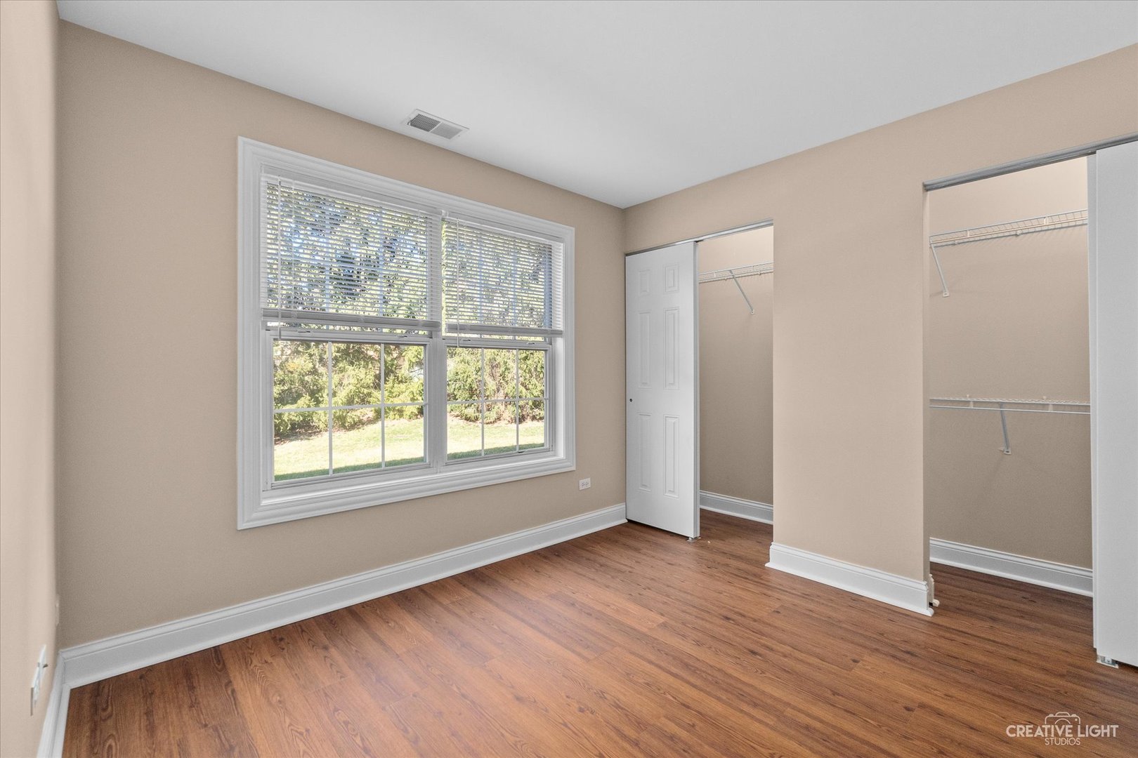 15 Foxcroft Road, Unit 135 Naperville, IL 60565 - Photo 12 of 18 an empty room with wooden floor and windows