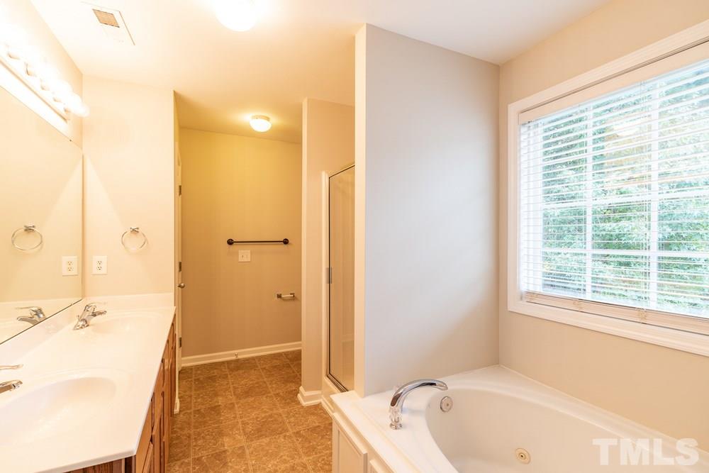 3513 Rendition Street Raleigh, NC 27610 - Photo 13 of 30 a bathroom with a tub shower and sink