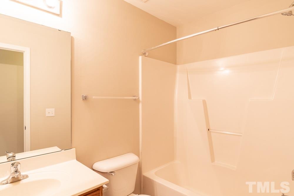 3513 Rendition Street Raleigh, NC 27610 - Photo 19 of 30 a bathroom with a shower a toilet and a sink