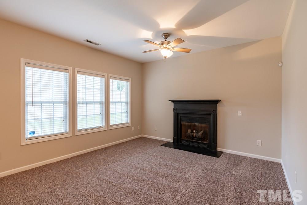 3513 Rendition Street Raleigh, NC 27610 - Photo 3 of 30 an empty room with windows and fireplace