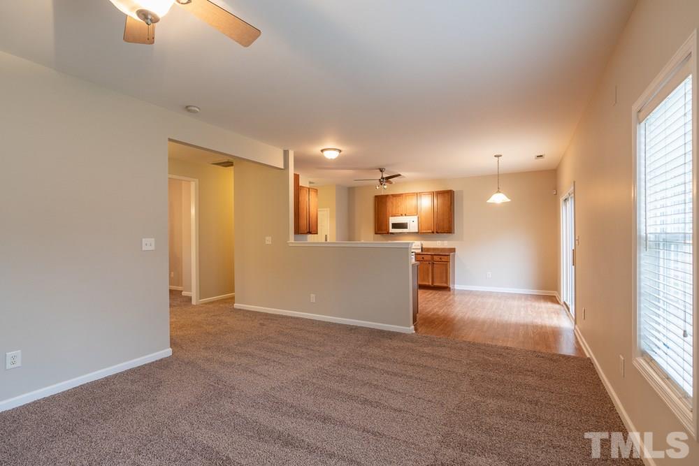 3513 Rendition Street Raleigh, NC 27610 - Photo 5 of 30 an empty room with windows and entrance to other room