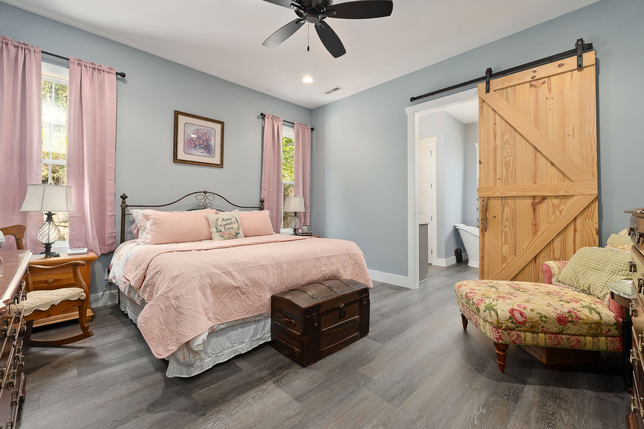 881 Eagle Mountain Road Granville, TN 38564 - Photo 20 of 49 a spacious bedroom with a bed a window and a chandelier