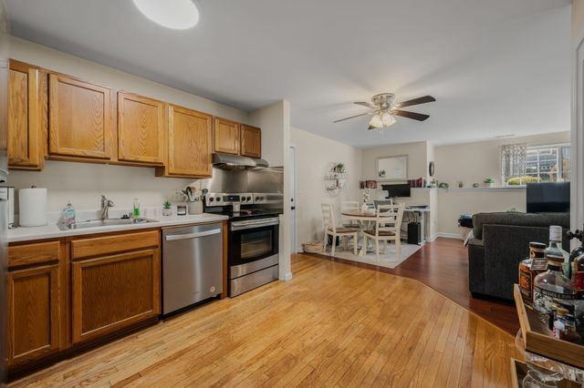 a kitchen with a sink appliances and cabinets