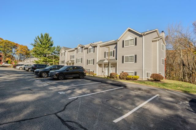 a couple of cars parked in front of a house