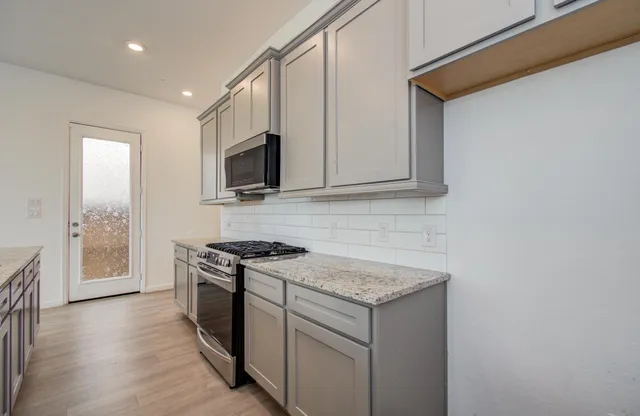 a kitchen with a stove and a microwave