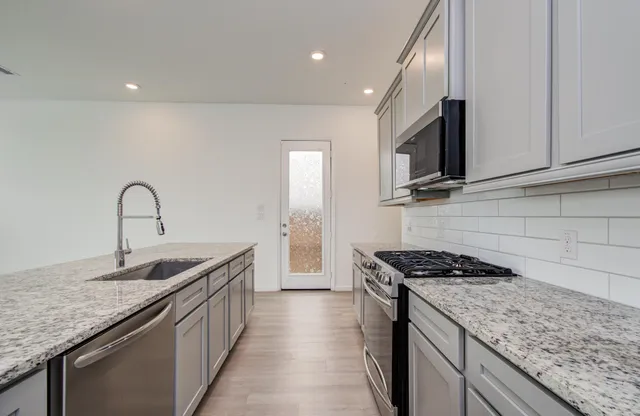 a kitchen that has a sink and a stove