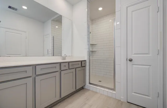a bathroom with a shower and a sink