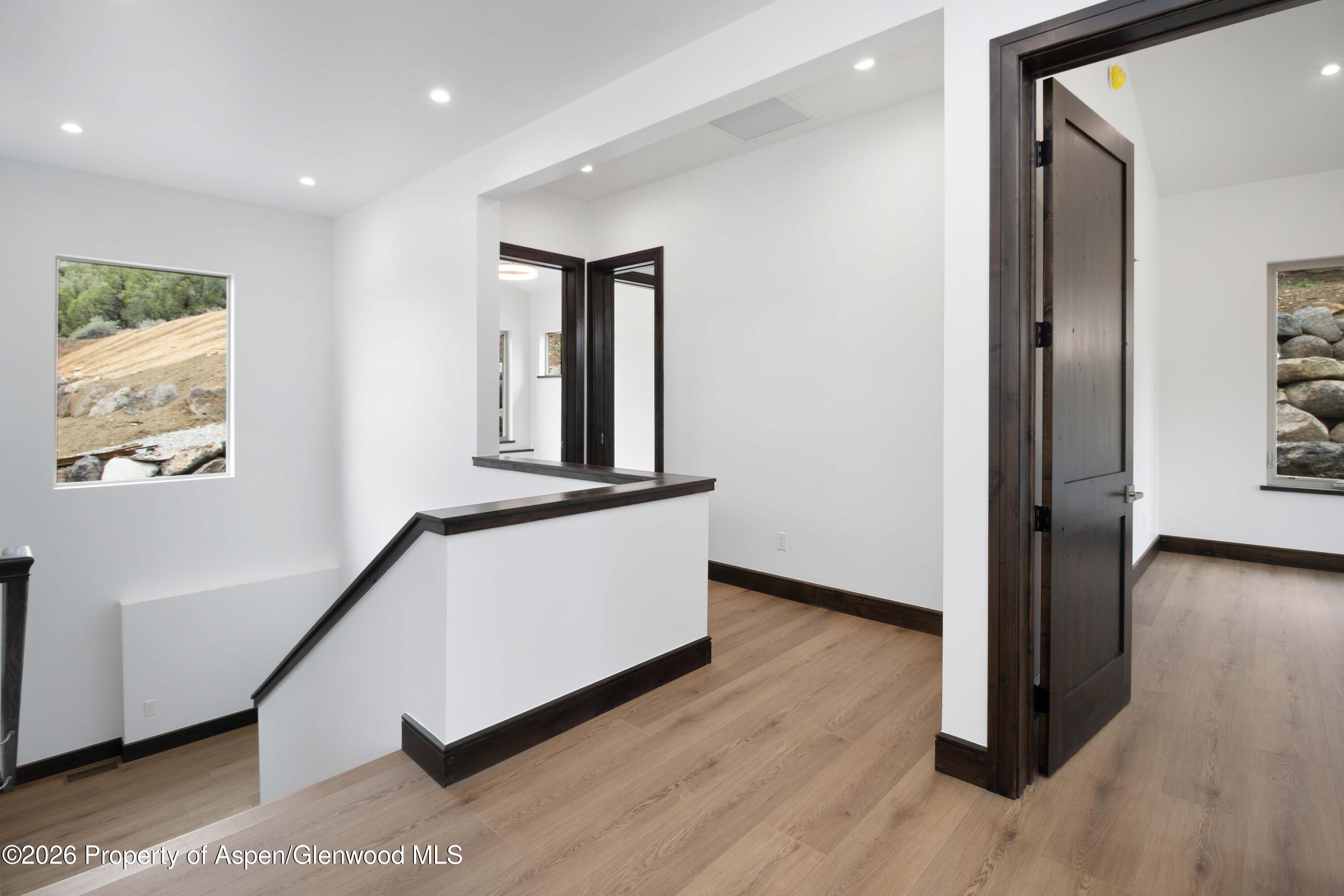 342 Faas Ranch Road New Castle, CO 81647 - Photo 14 of 29 a hallway with wooden floor and stairs