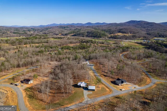 an aerial view of residential house and sandy dunes