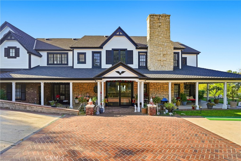 front view of a brick house with a yard