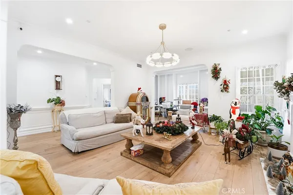 a living room with furniture and a chandelier