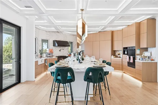 a view of a dining room kitchen with furniture and a chandelier