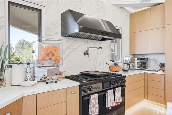 a kitchen with stainless steel appliances granite countertop a sink stove and cabinets