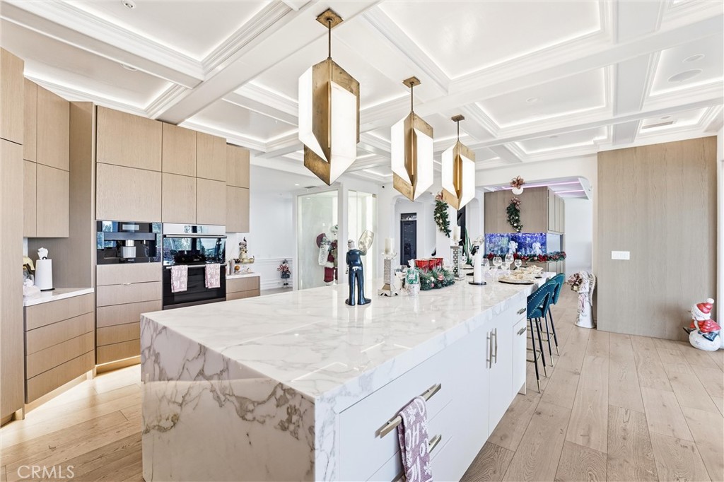 381 South Henning Way Anaheim, CA 92807 - Photo 17 of 55 a dining hall with stainless steel appliances kitchen island granite countertop a table chairs and a view of living room