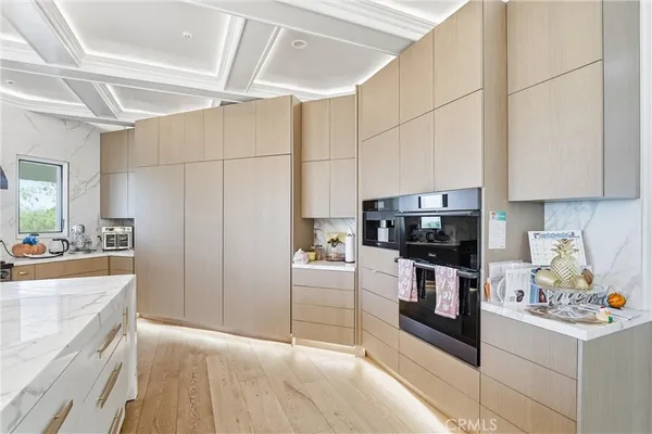 a kitchen with stainless steel appliances a stove a sink and a refrigerator
