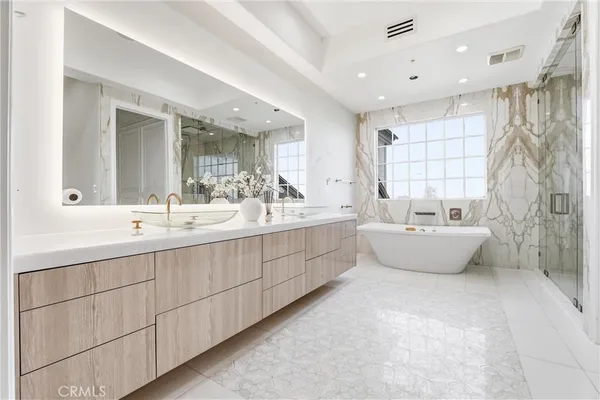 a bathroom with a tub a toilet and a shower
