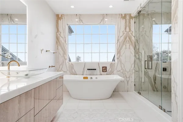 a bathroom with a bathtub and next to a window