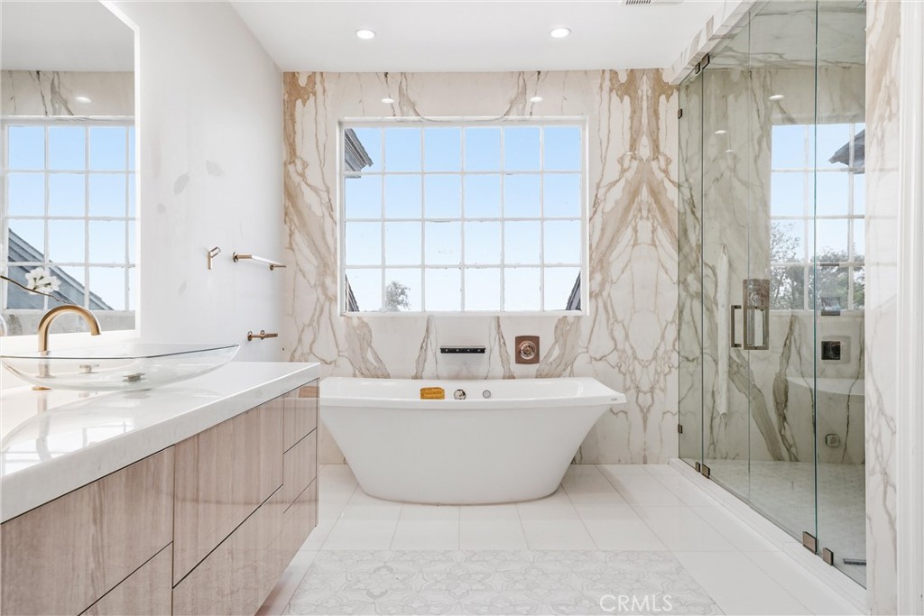 381 South Henning Way Anaheim, CA 92807 - Photo 35 of 55 a bath tub sitting next to a white sink a shower and a sink