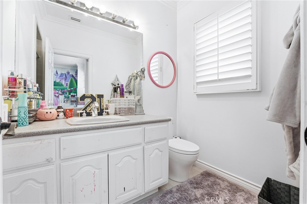 381 South Henning Way Anaheim, CA 92807 - Photo 45 of 55 a bathroom with a toilet a sink and a mirror