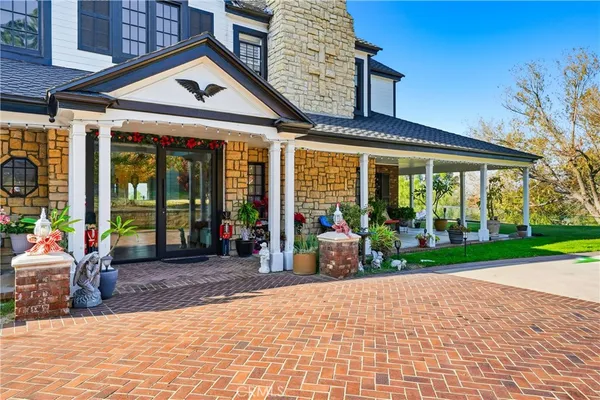 a view of a house with backyard porch and sitting area