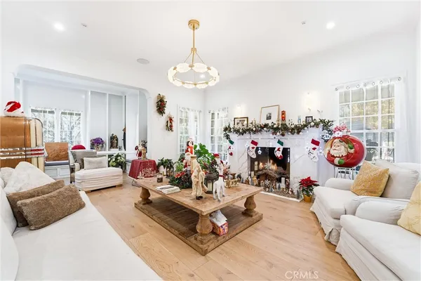 a living room with furniture gym equipment and a chandelier