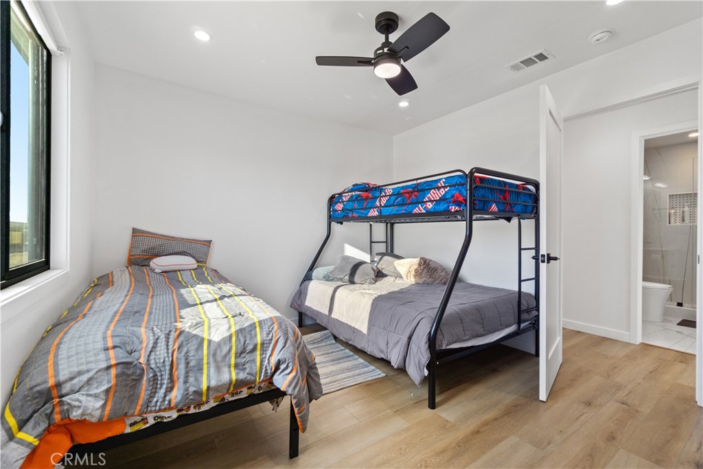 64654 Sun Mesa Road Joshua Tree, CA 92252 - Photo 14 of 25 a bedroom with two beds and a ceiling fan