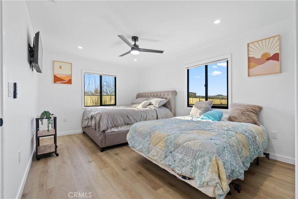 64654 Sun Mesa Road Joshua Tree, CA 92252 - Photo 16 of 25 a bedroom with two beds and painting on the wall
