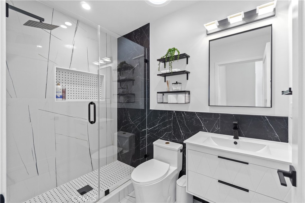64654 Sun Mesa Road Joshua Tree, CA 92252 - Photo 18 of 25 a bathroom with a sink a toilet and shower