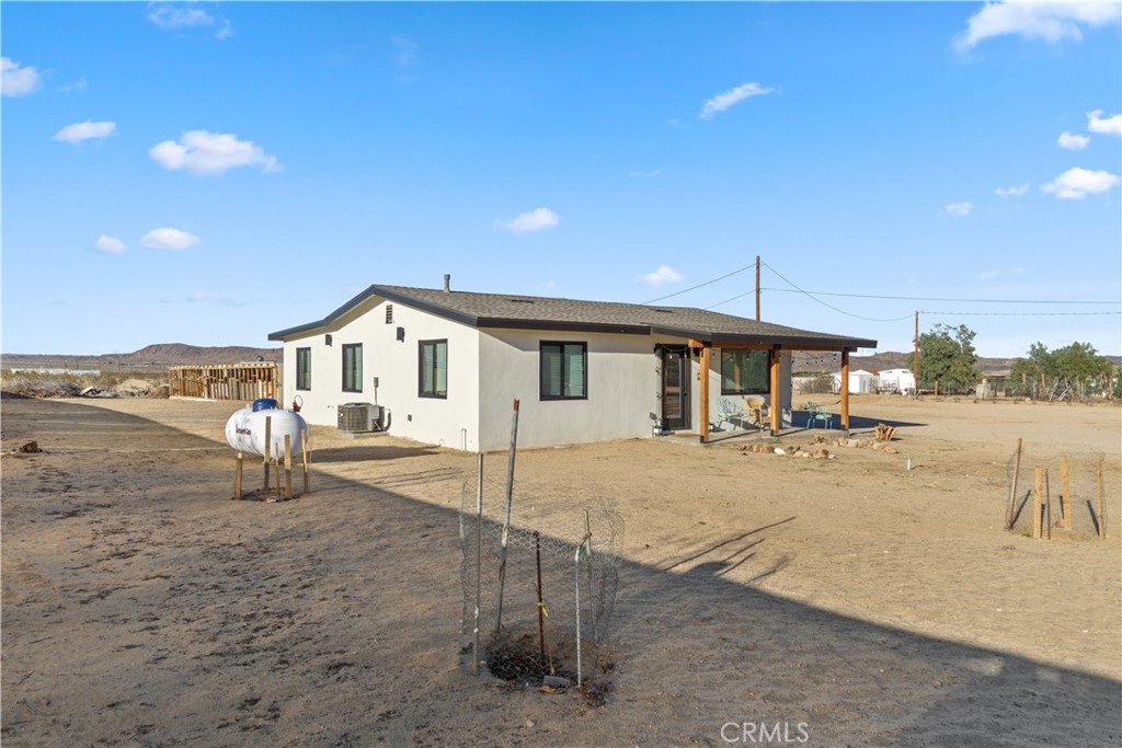64654 Sun Mesa Road Joshua Tree, CA 92252 - Photo 20 of 25 a view of a house with backyard and sitting area