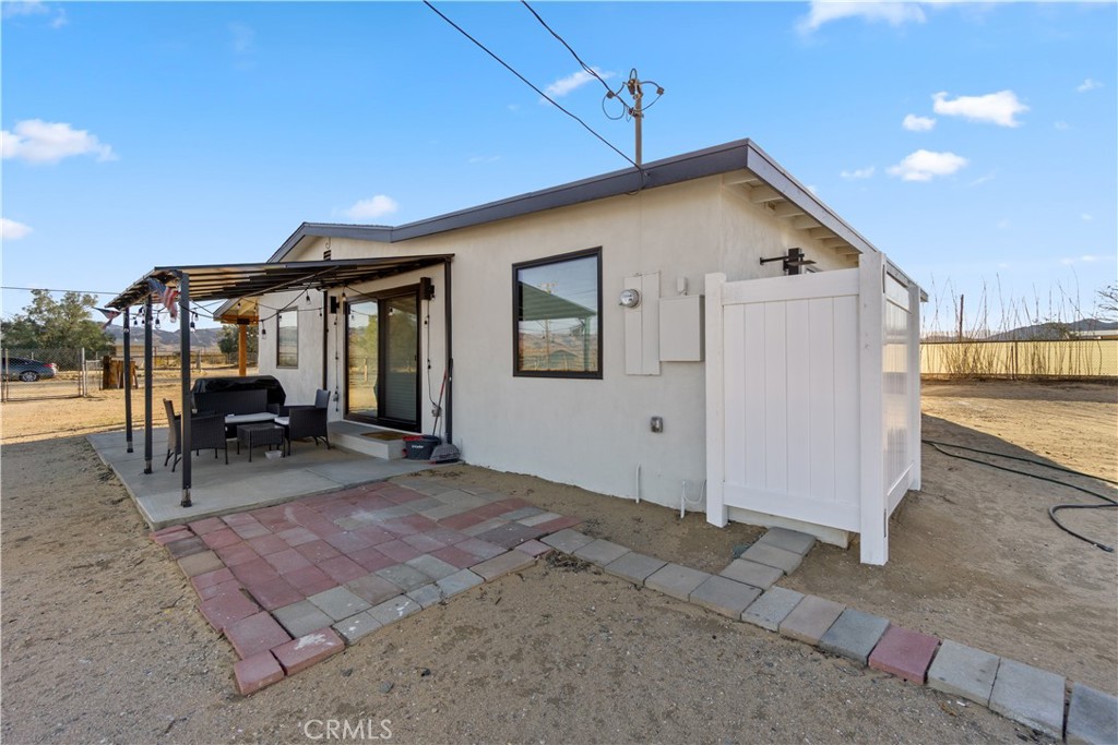 64654 Sun Mesa Road Joshua Tree, CA 92252 - Photo 21 of 25 a view of a house with backyard and sitting area