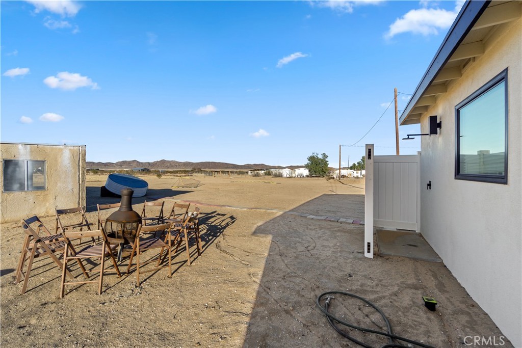 64654 Sun Mesa Road Joshua Tree, CA 92252 - Photo 23 of 25 a view of a terrace with chairs