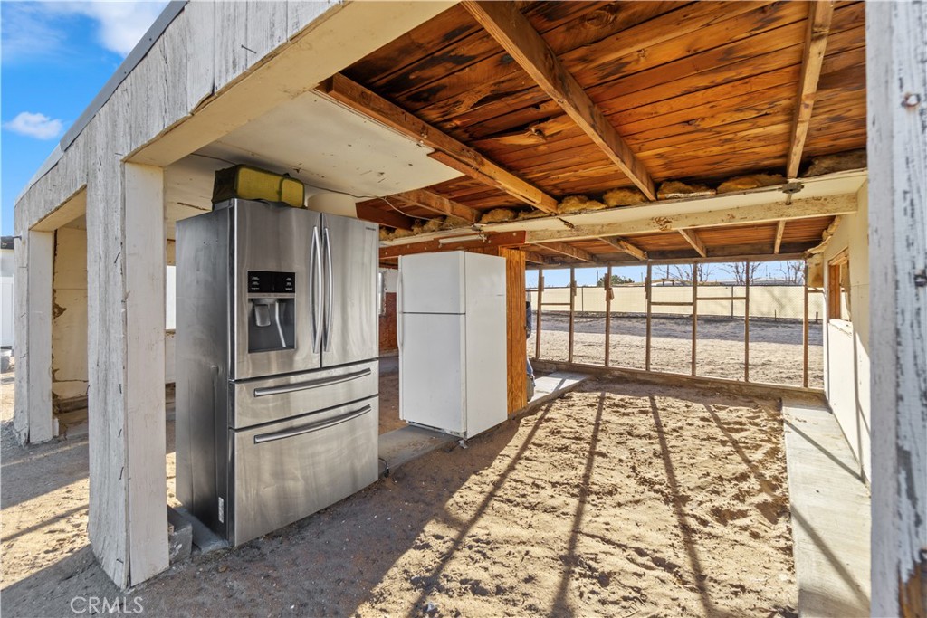 64654 Sun Mesa Road Joshua Tree, CA 92252 - Photo 24 of 25 a view of a refrigerator in kitchen and an empty room