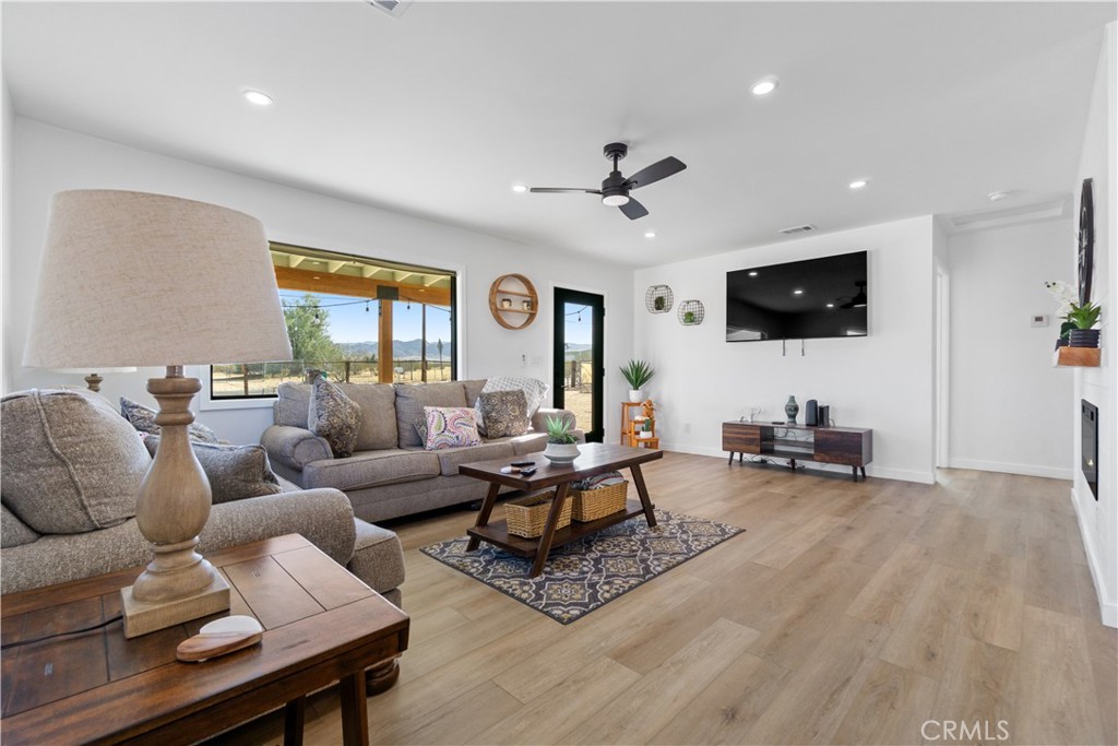 64654 Sun Mesa Road Joshua Tree, CA 92252 - Photo 3 of 25 a living room with furniture and a flat screen tv