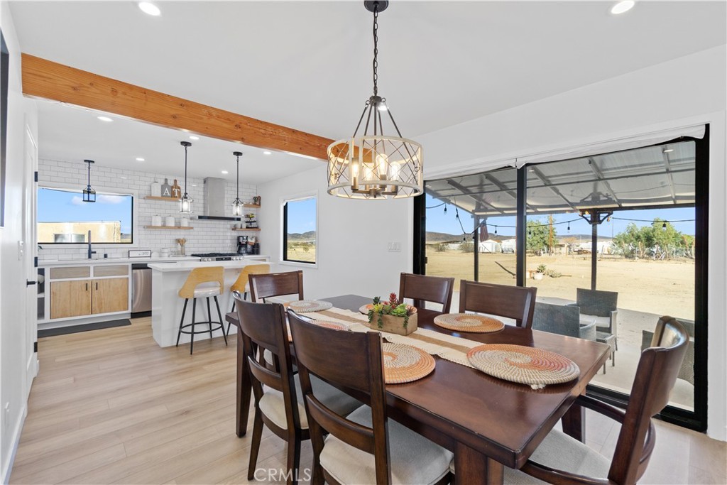 64654 Sun Mesa Road Joshua Tree, CA 92252 - Photo 5 of 25 a dining room with furniture a chandelier and wooden floor