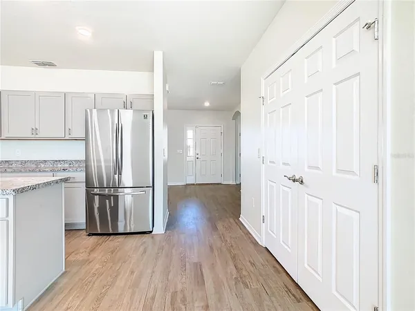 a bathroom with a granite countertop toilet and a sink