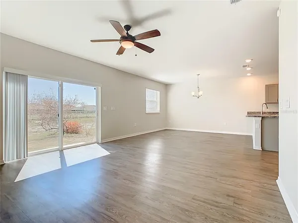 an empty room with closet and fan