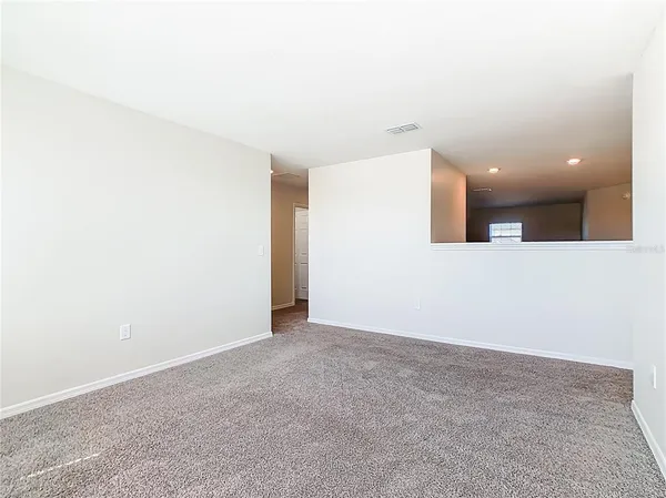 a view of empty room with ceiling fan