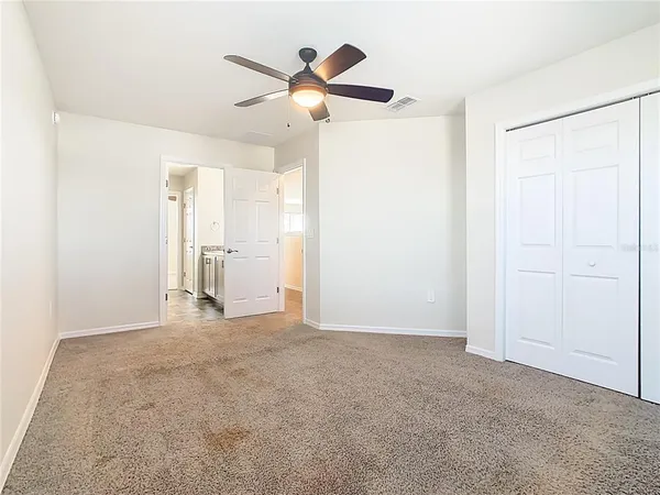 a bathroom with a sink a toilet a mirror and shower
