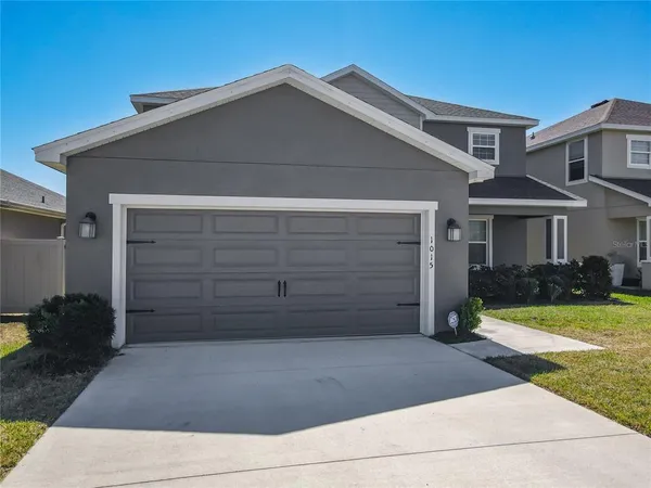 a front view of a house with garage