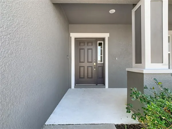 a view of a hallway with wooden walls and entryway